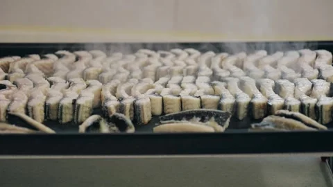 Fresh sliced eel grilling on a hot plate, Korean food Stock Footage 325975469
