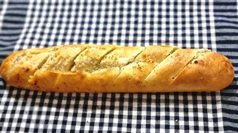 Fresh Sliced Garlic Bread on a Checkered Tablecloth Stock Photos