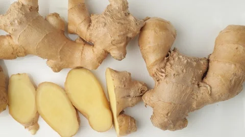Fresh sliced ginger root moving on white background Stock Footage 344604295