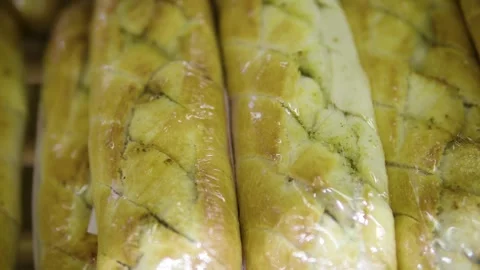 Fresh Sliced Loaves Packed in Clear Plastic Bags on Bakery Display Shelf Stock Footage 330111030