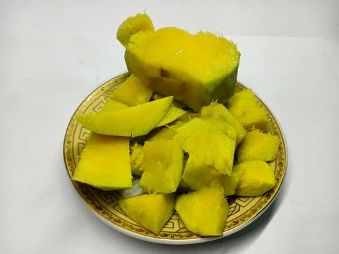 Fresh sliced mango chunks on a plate Stock Photos