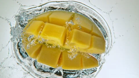 Fresh sliced mango falling into water Stock Footage 171542126