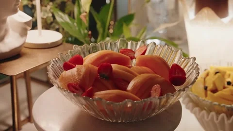 Fresh sliced melon with strawberries on elegant dessert table Stock Footage 321899717