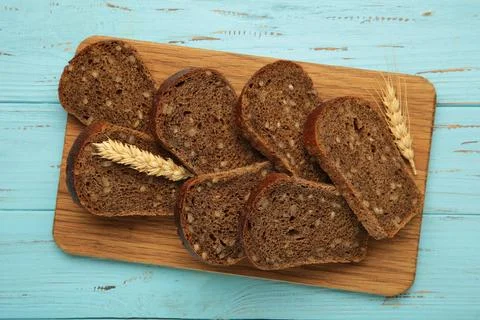 Fresh sliced rye bread loaf on blue background Stock Photos