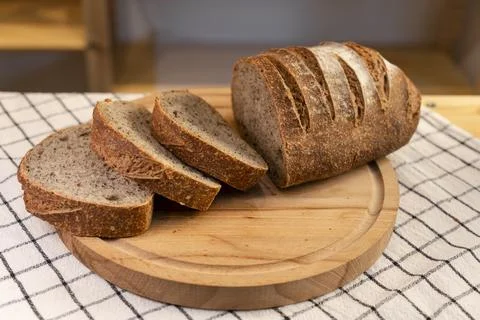 Fresh sliced rye bread loaf on wooden board Stock Photos