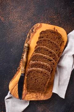 Fresh sliced rye bread on rusty background Stock Photos
