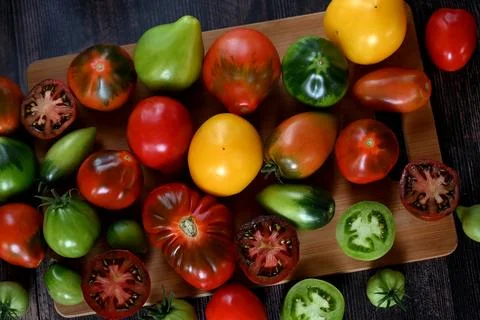 Fresh sliced tomatoes on black background, copy space Stock Photos