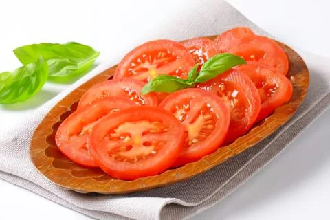 Fresh sliced tomatoes on bread with basil Stock Photos