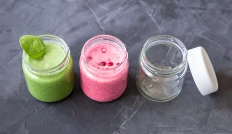 Fresh smoothie variations in jars ans an empty jar Stock Photos