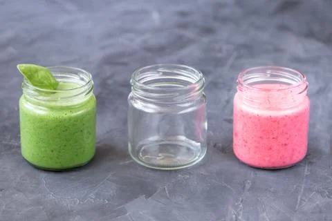 Fresh smoothie variations in jars ans an empty jar Stock Photos