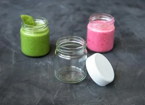 Fresh smoothie variations in jars ans an empty jar Stock Photos