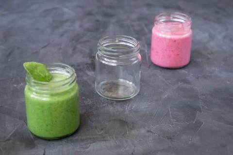 Fresh smoothie variations in jars ans an empty jar Stock Photos