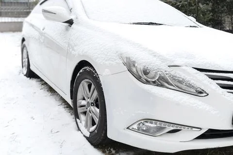 Fresh Snow layer on windscreen, windshield, window of car in driveway parking Stock Photos