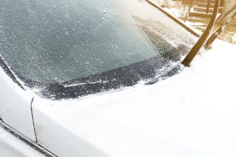 Fresh Snow layer on windscreen, windshield, window of car. automobile in Stock Photos