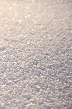 Fresh snow texture with ice crystals sparkling in the sun Stock Photos