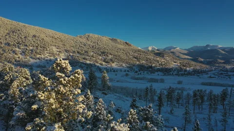 Fresh snowfall blankets the roads and mountainside in Colorado Stock Footage 247364248