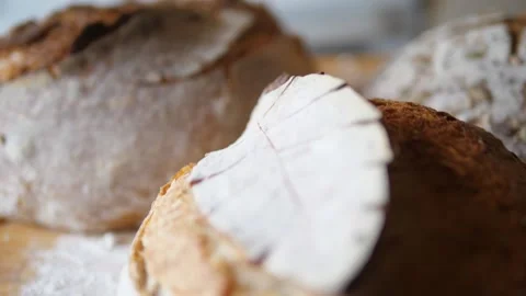 Fresh sourdough bread on kitchen table fly over loaves Stock Footage 196000051