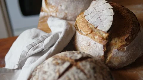 Fresh sourdough bread on kitchen table fly over loaves Stock Footage 196000136