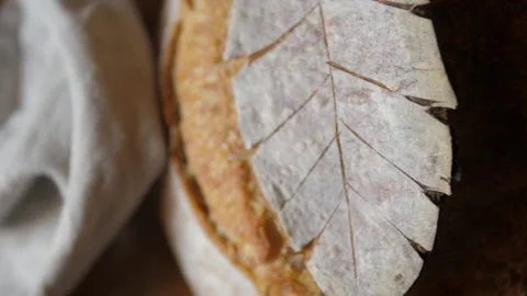 Fresh sourdough bread on kitchen table birdseye veiw pan right Stock Footage 196000168
