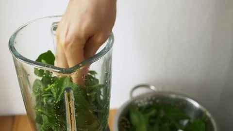 Fresh spinach leaves being added into a blender Video stock 76048066