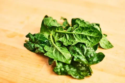 Fresh spinach leaves on wooden table Stock Photos