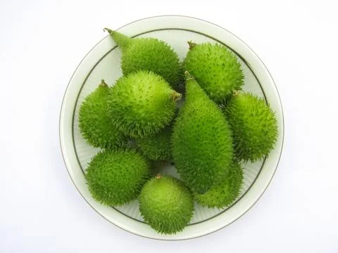 Fresh Spiny gourds in a plate on white background  Stock-Fotos