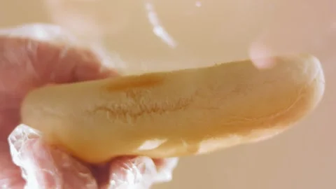 Fresh split hot dog bun held open for filling, 4K Video stock 341121983