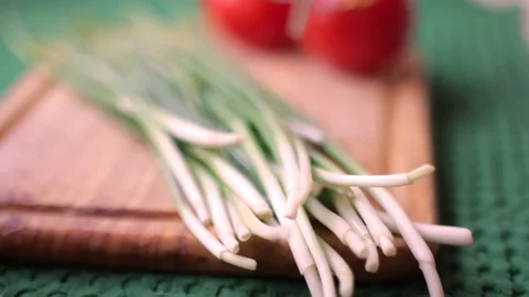 Fresh spring onions in a row on old wooden table focusing Stock Footage 80991280