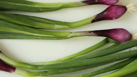 Fresh spring red onion dolly shot on white background Stock Footage 340526280