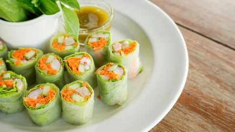 Fresh spring rolls with assorted vegetables with spicy sauce. Stock Photos