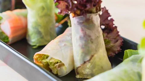 Fresh spring rolls filled with vegetables and greens Stock Photos