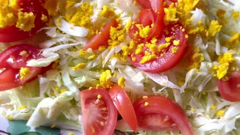 Fresh spring salad with tomatoes, cabbage, and eggs, viewed from the top, i.. Stock Footage 234554451