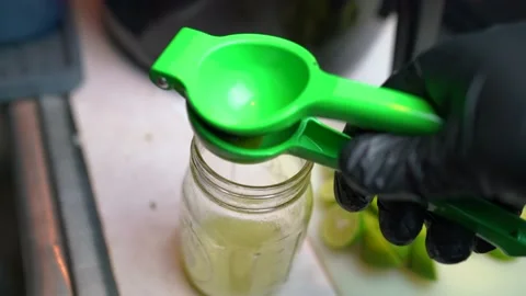 Fresh squeezed key lime juice into mason jar Stock Footage 225333775