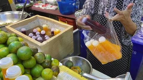 Fresh Squeezed Thai Pomegranate Orange Juice Vendor Puts In Plastic Bag Take Out Stock-Footage 226247053