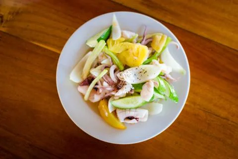 Fresh squid with pineapple in restaurant Stock Photos