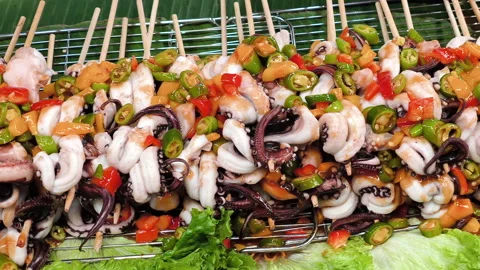 Fresh squid on a stick, Grilled Squid Tentacles on a Stick, Thai street foo.. Stock Footage 294294741