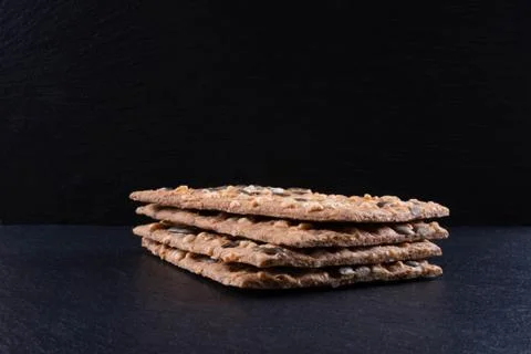 Fresh stack of crackers on a black stone on a table Stock Photos