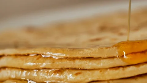 Fresh stacked pancakes is doused with maple syrup - sweet delicious breakfast Stock Footage 153669797
