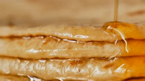 Fresh stacked pancakes is doused with maple syrup - sweet delicious breakfast Stock Footage 153672891