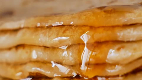 Fresh stacked pancakes is doused with maple syrup - sweet delicious breakfast Stock Footage 153673267
