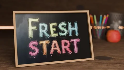 Fresh start bright chalkboard message on wooden table with colorful art supplies Stock Footage 313879140