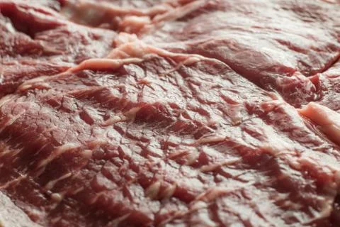 Fresh steak on marble background. Uncooked beefsteak cooking on a kitchen Stock Photos