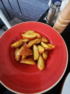 Fresh steak potatoes on the red table Stock Photos