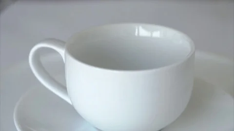 Fresh steaming aromatic coffee being poured into a white cup. Stock Footage 76663794