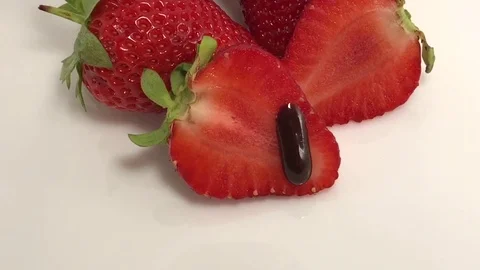 Fresh strawberries in chocolate Up white background authentic motion Stock Footage 80556928