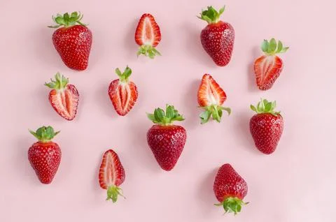 Fresh strawberries creative flat lay close-up on a pink background. Fresh Stock Photos