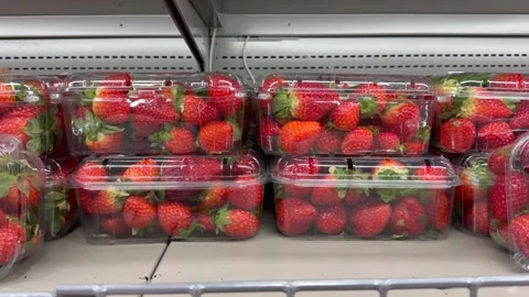 Fresh strawberries packed in transparent boxes on refrigerated shelf. Close view Stock Footage 328352021