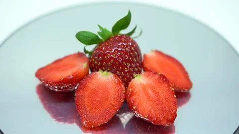 Fresh strawberry and slice turn around on grey background Stock Footage 301634558