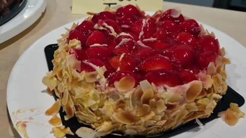 Fresh strawberry cake (Erdbeertorte) on a buffet table, beautifully presented Stock Footage 337549687