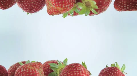 Fresh strawberry dropped into water Stock Footage